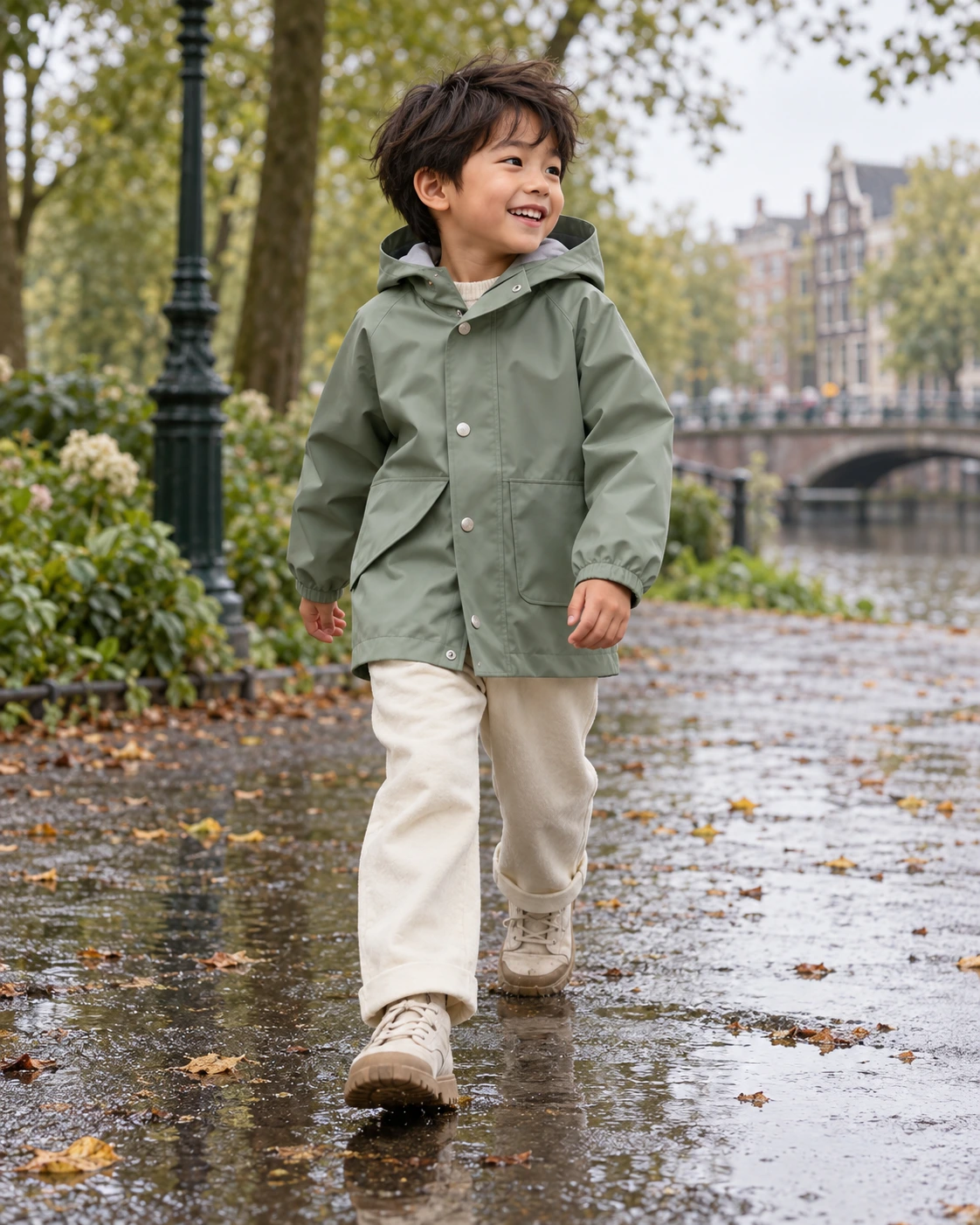 A child exploring a leafy park in a sage raincoat